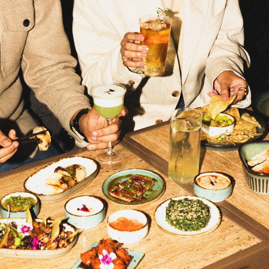 A black Chanel headband with light gold metal detail
